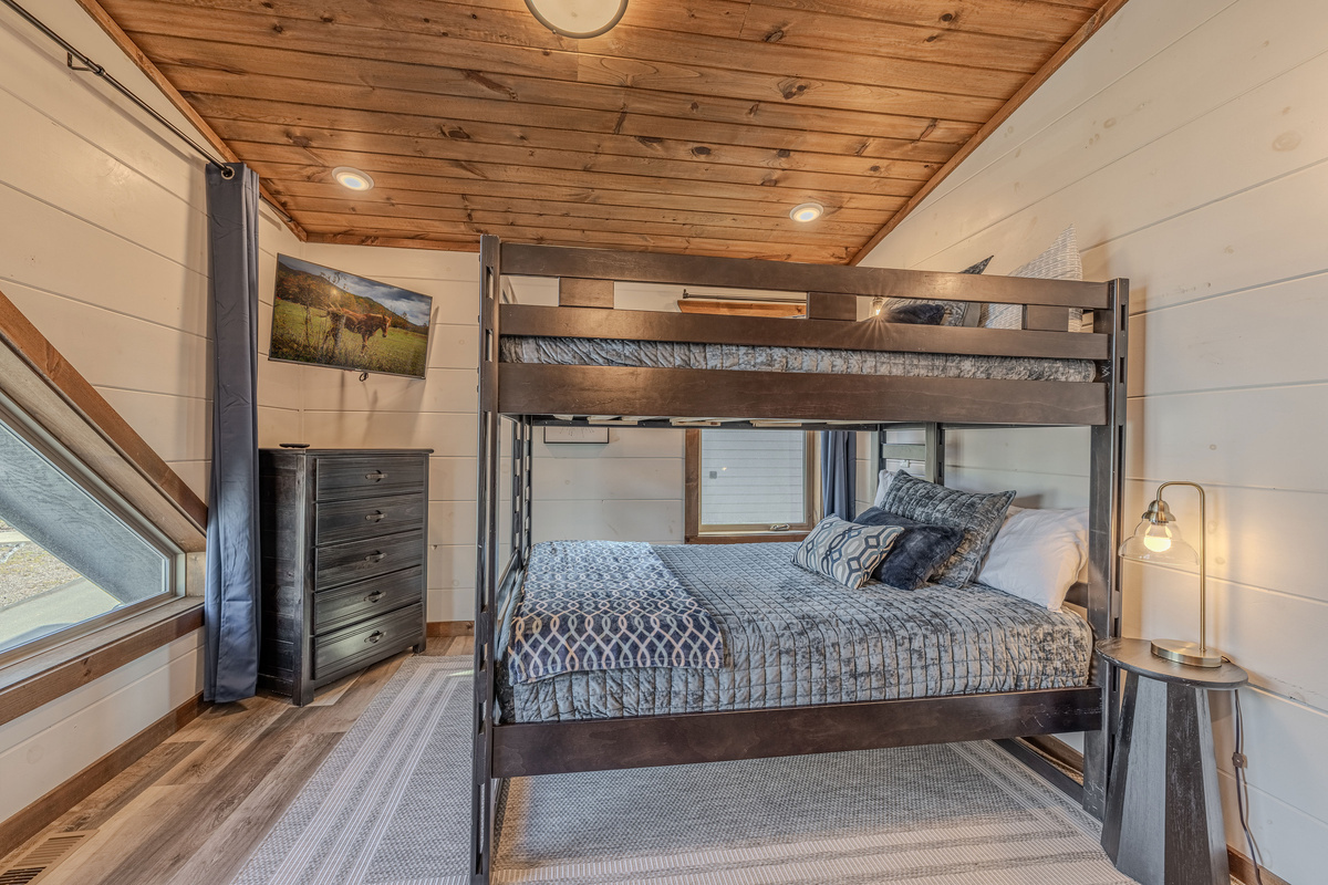 Full-sized bunk room is arranged to make group stays comfortable, blackout curtains keep it dark when needed.
