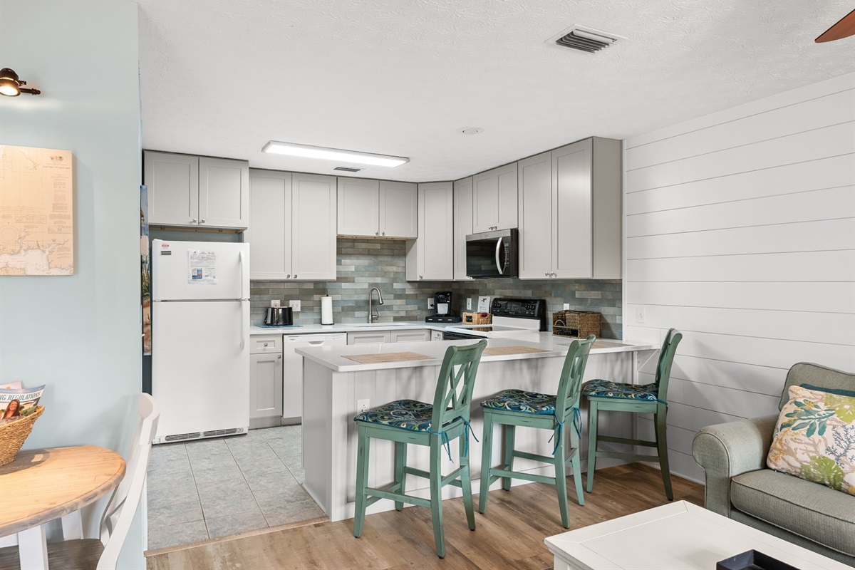 Fully refreshed kitchen with brand-new cabinets and stocked kitchen with tons of cooking utensils, cookware, and everything you need to prepare meals.