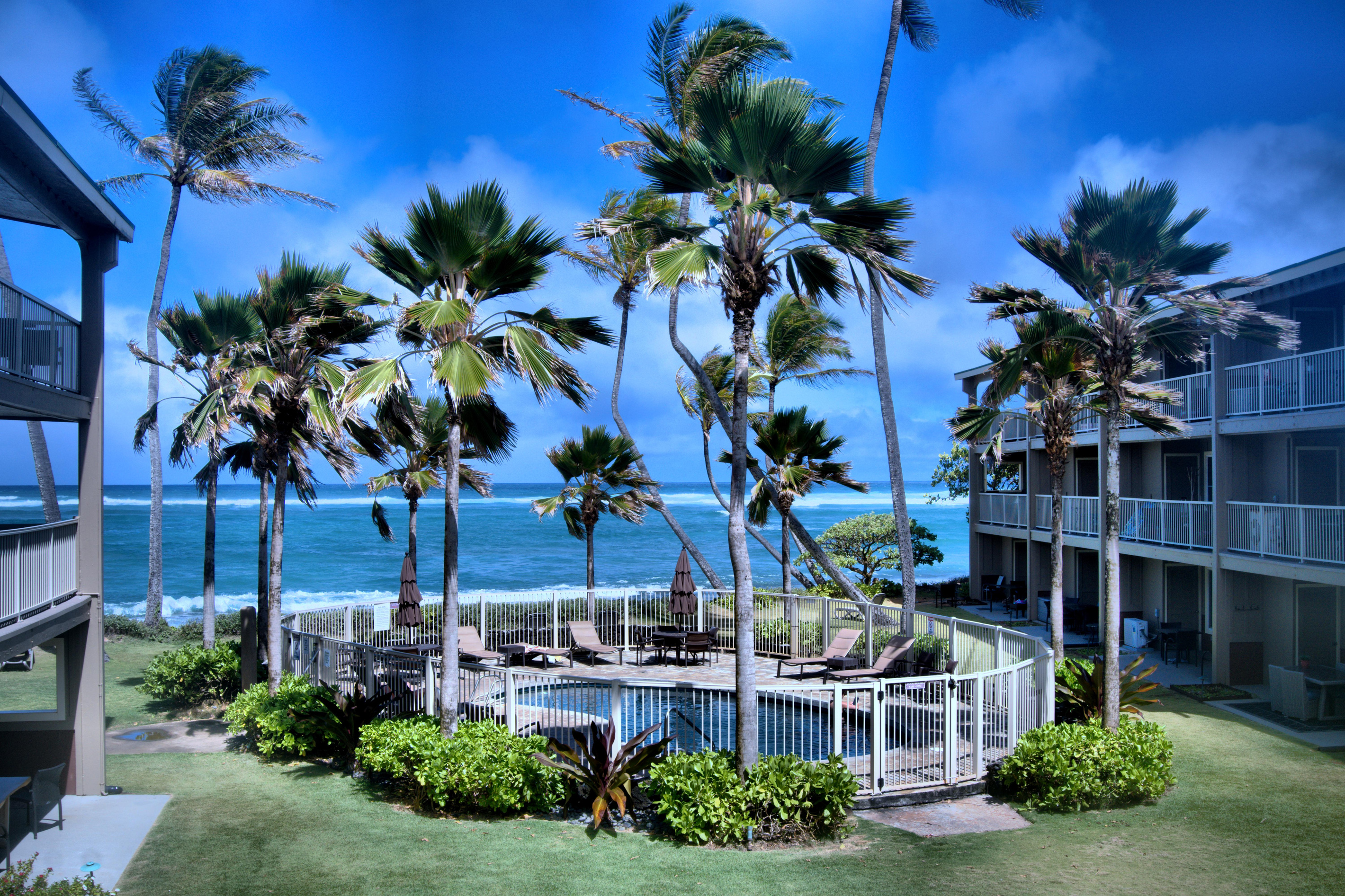 View of the blue ocean and pool from lanai
