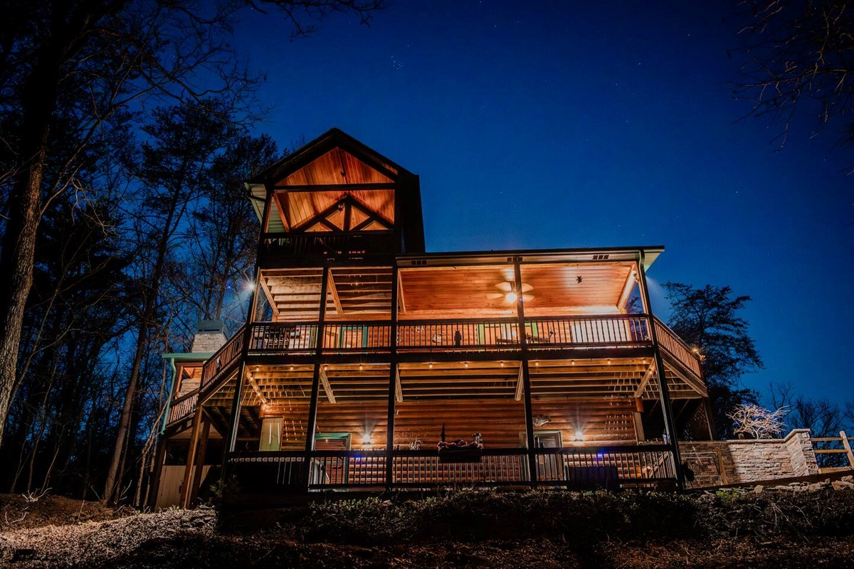 View of the cabin and multiple decks for your group to gather.  Includes hot tub, hammock, and other seating options.