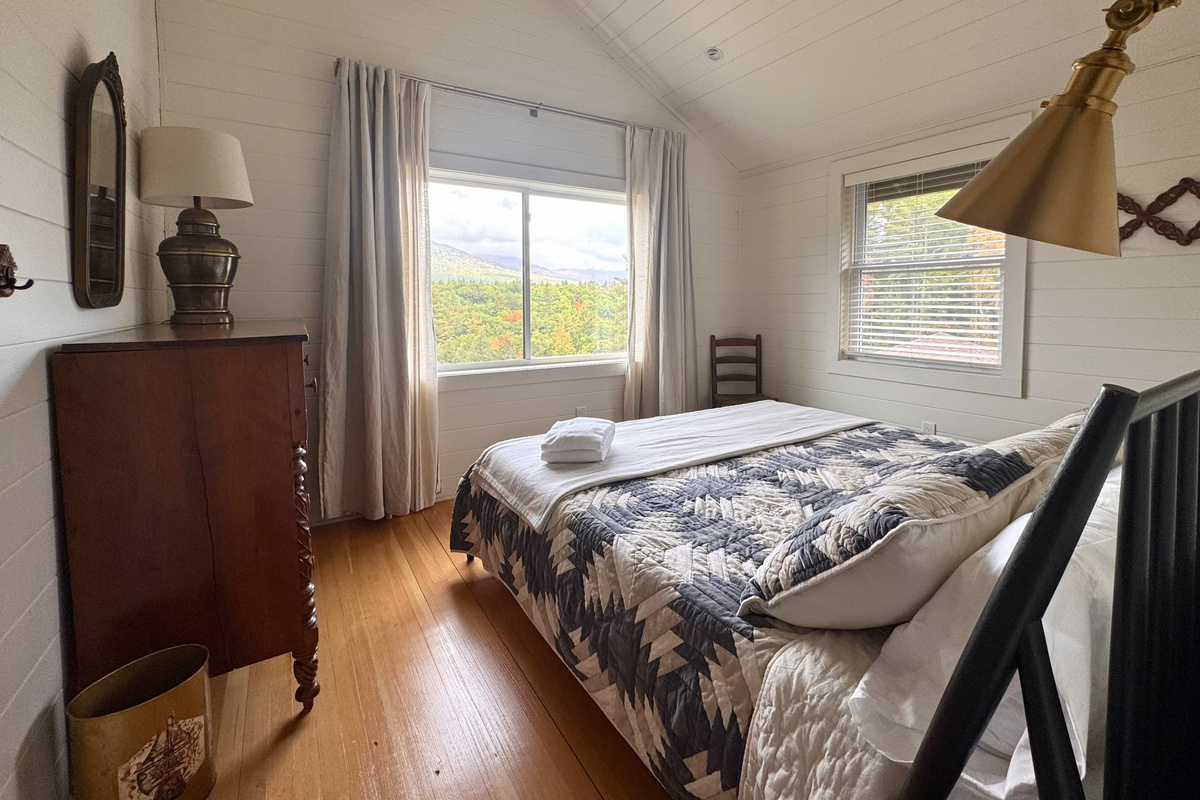 Wake up to beautiful mountain and forest views from this cozy, light-filled bedroom.