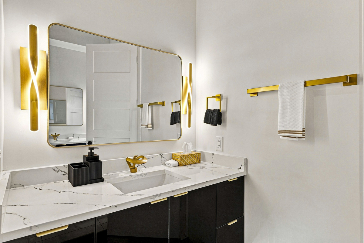 Elegant marble and gold accents create a chic retreat for your stay!