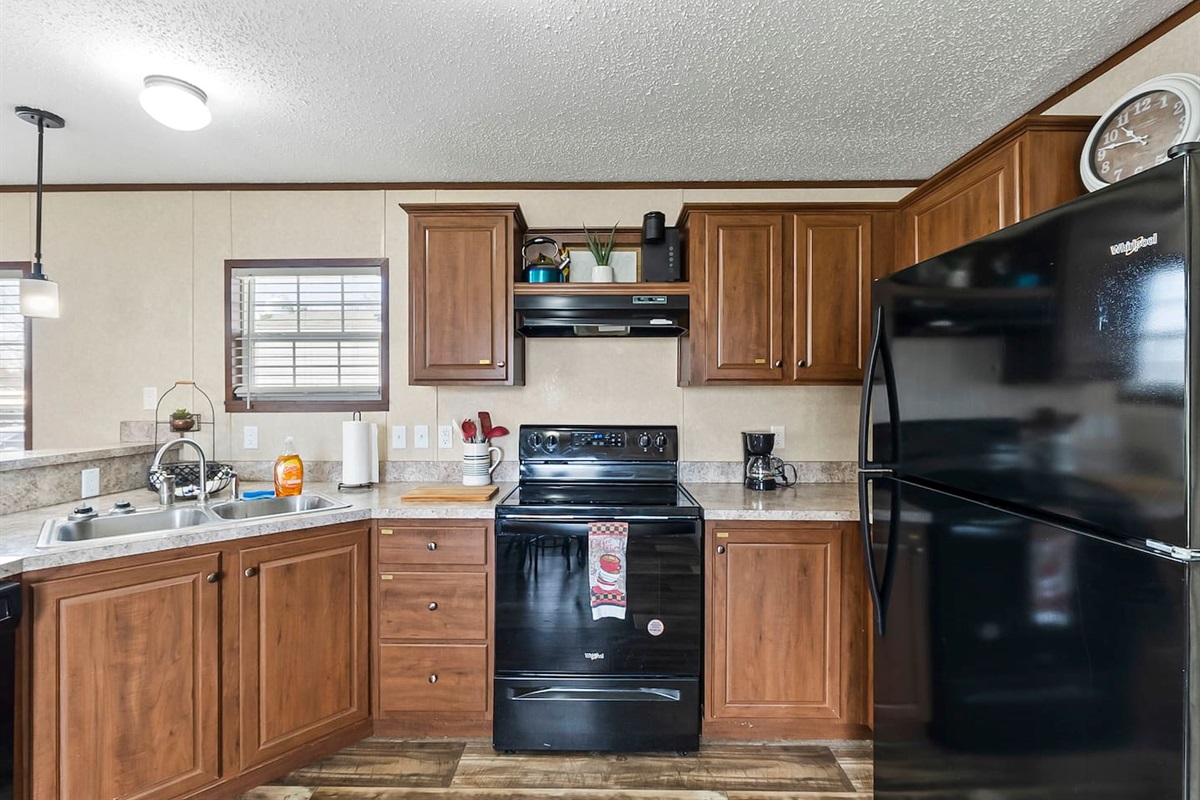 Bright and functional kitchen layout featuring full-size appliances, generous cabinetry, and a clean, open design.