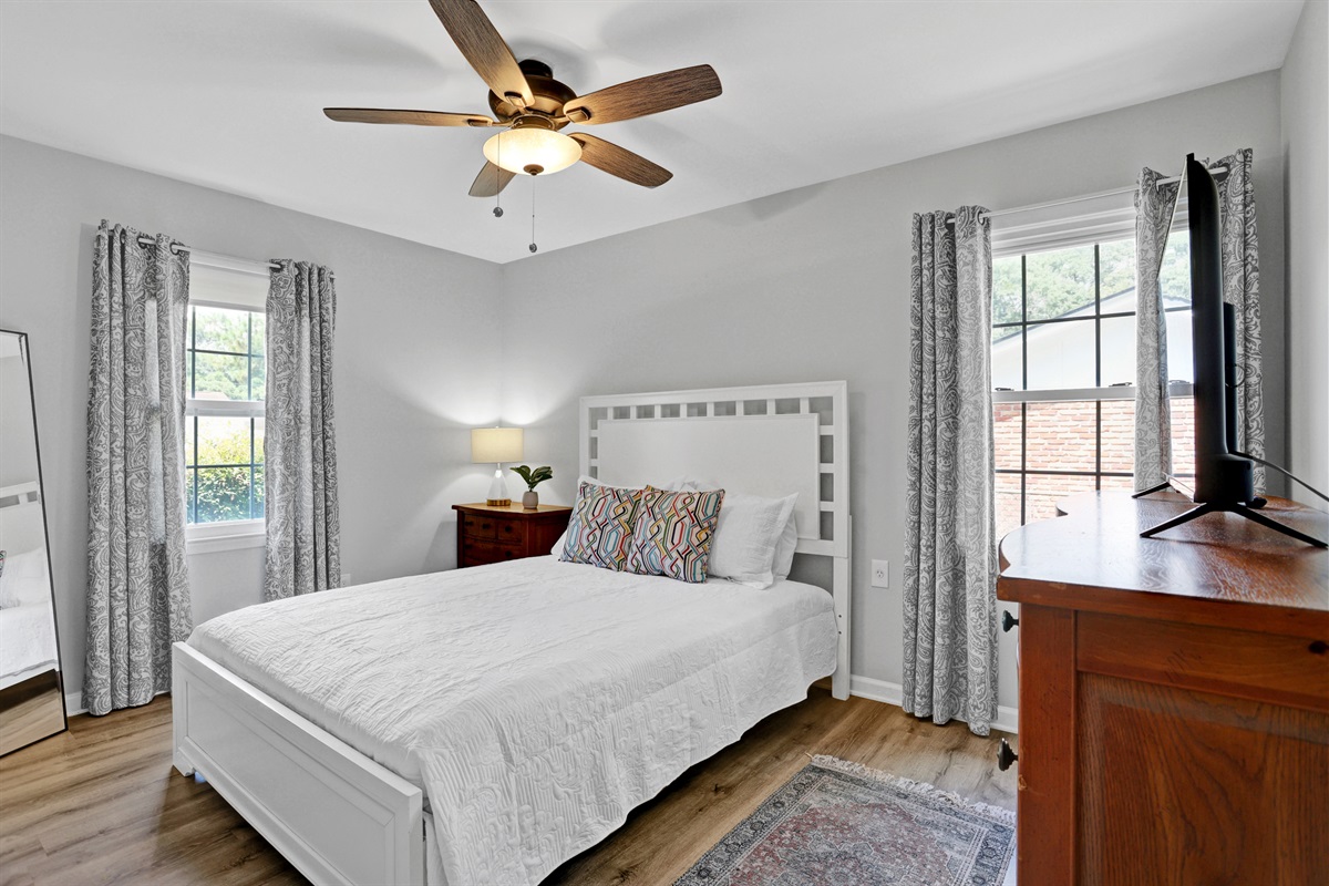 Charming and cozy, the queen bedroom offers a restful retreat with soft linens, calming colors, and a touch of Southern style.