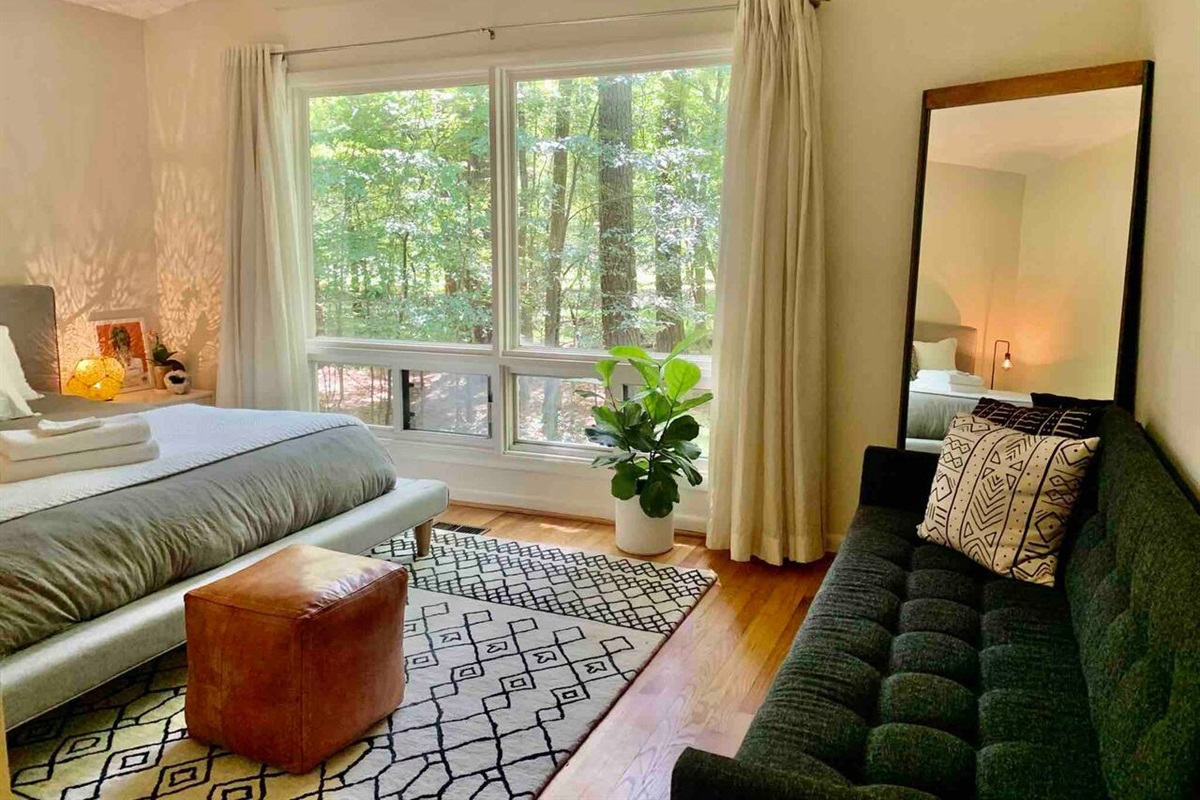 Wake up to a wall of windows and nothing but green &mdash; open the shades for the full woodland view, or keep them drawn and sleep in.