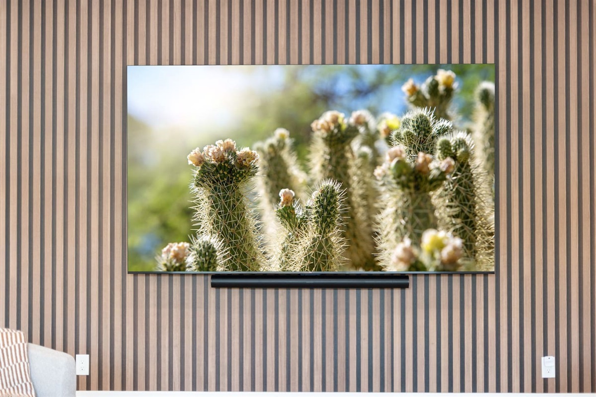 Large smart TV with soundbar set against a modern wood accent wall — perfect for movie nights and streaming entertainment.
