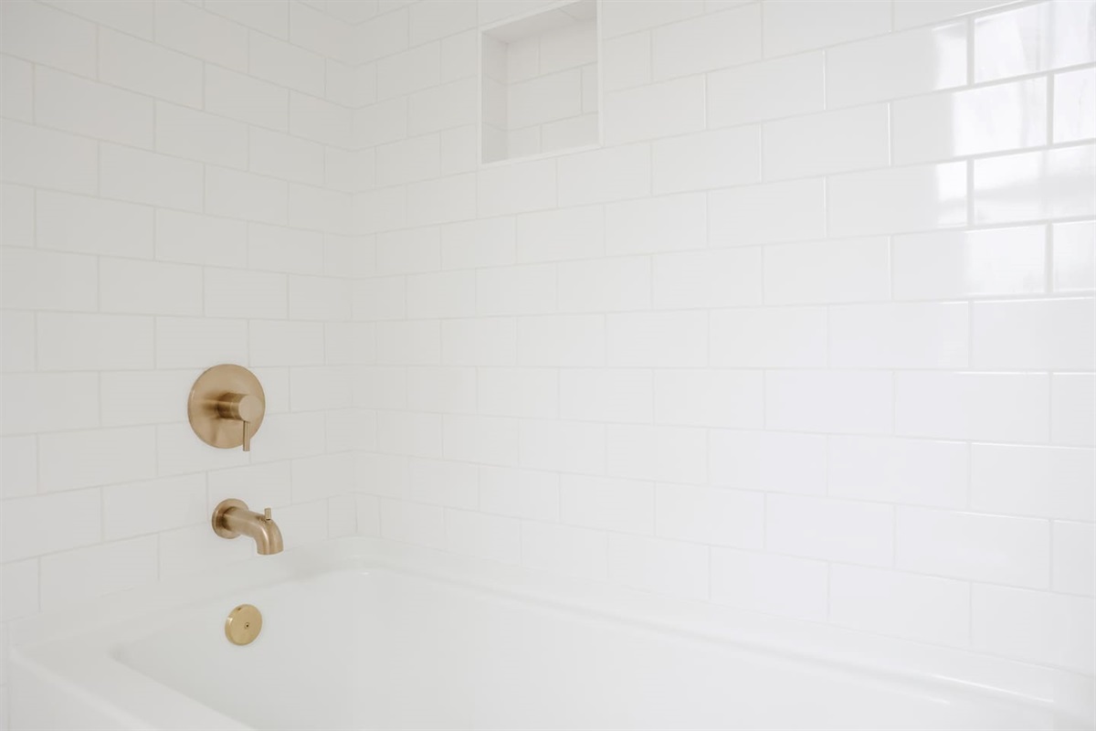 The spacious "sunrider room" features two queen beds, a spacious double-door closet, a full bath with a shower, smart TV and coastal photography. 