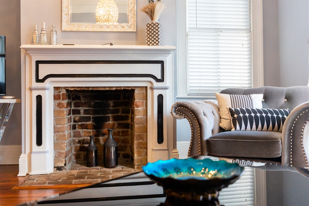 Touches like the original decorative fireplace add timeless character to the space.