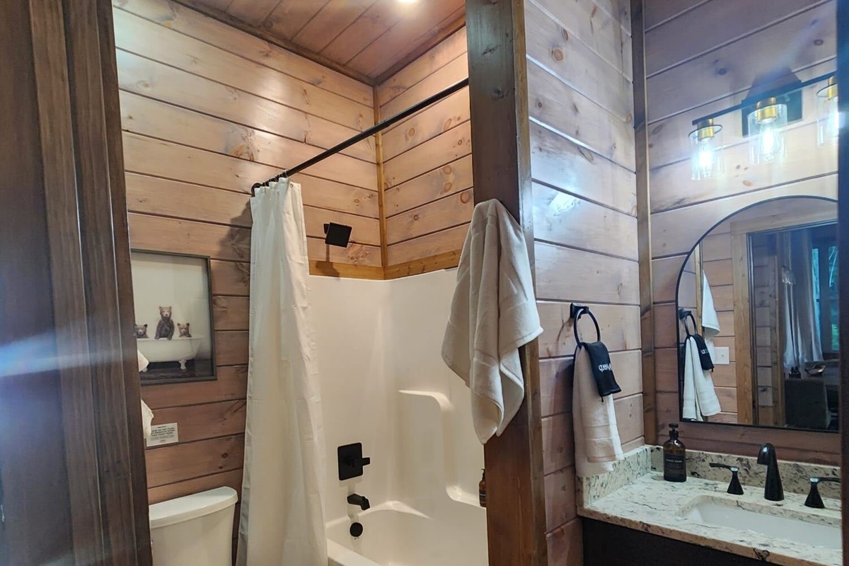 Bathroom with double sink vanity and shower