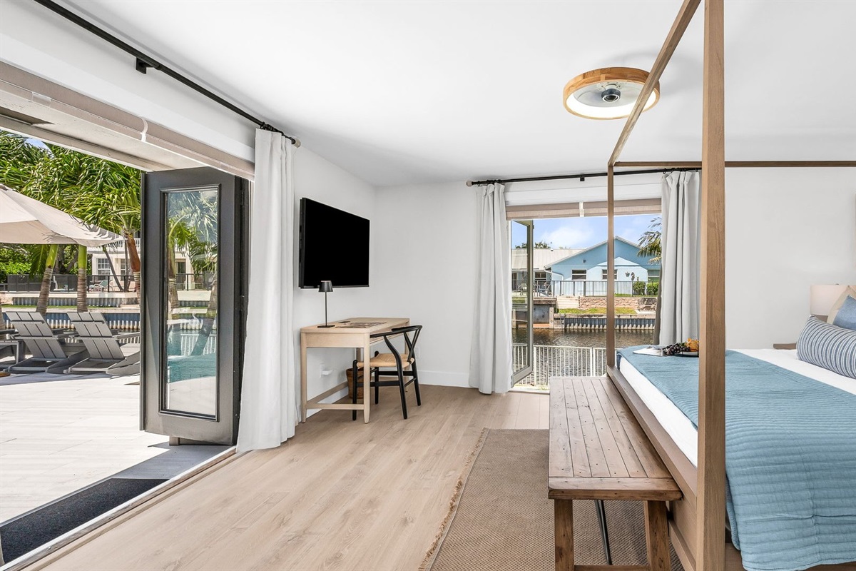 The primary king suite feels like your own private resort—featuring panoramic views of the pool and lake, seamless indoor-outdoor flow, and a newly renovated spa-inspired ensuite. Thoughtfully styled with designer finishes.