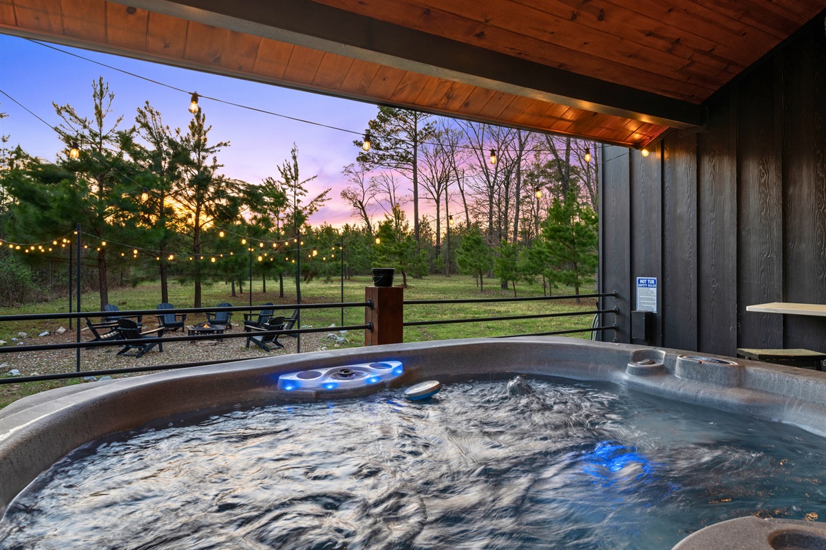 The covered hot tub area offers a cozy and secluded place to unwind, whether you’re soaking under the stars in the evening or easing into a slow morning surrounded by nature.