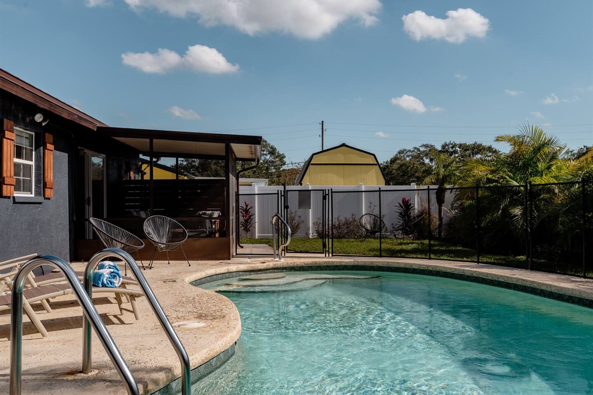 Heated pool with safety fence