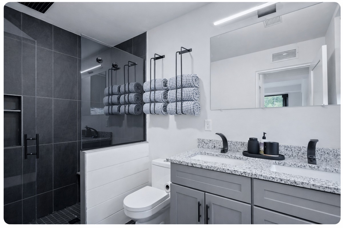 Primary en suite bathroom provides a luxurious spa like shower experience.