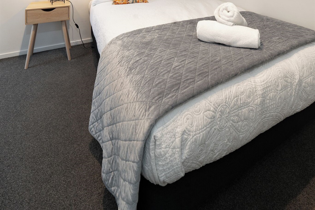 Soft natural light and the Fernhill setting give Bedroom 2 a calm alpine feel between Queenstown outings.
