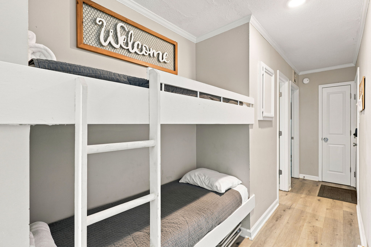 A comfortable bunk bed space designed to maximize sleeping arrangements while adding a fun coastal touch to your beach getaway