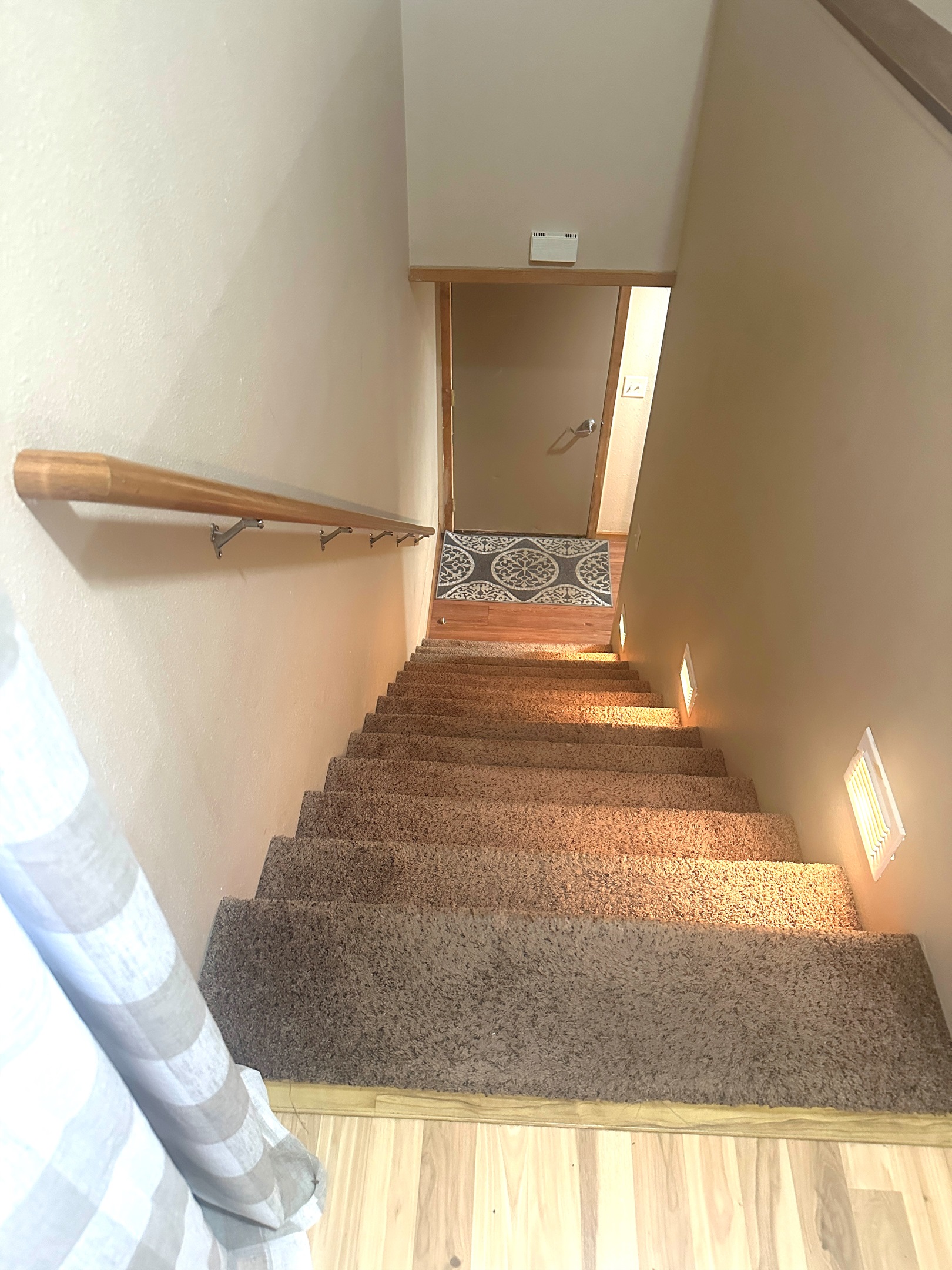 The bedrooms are down the stairs from the kitchen.