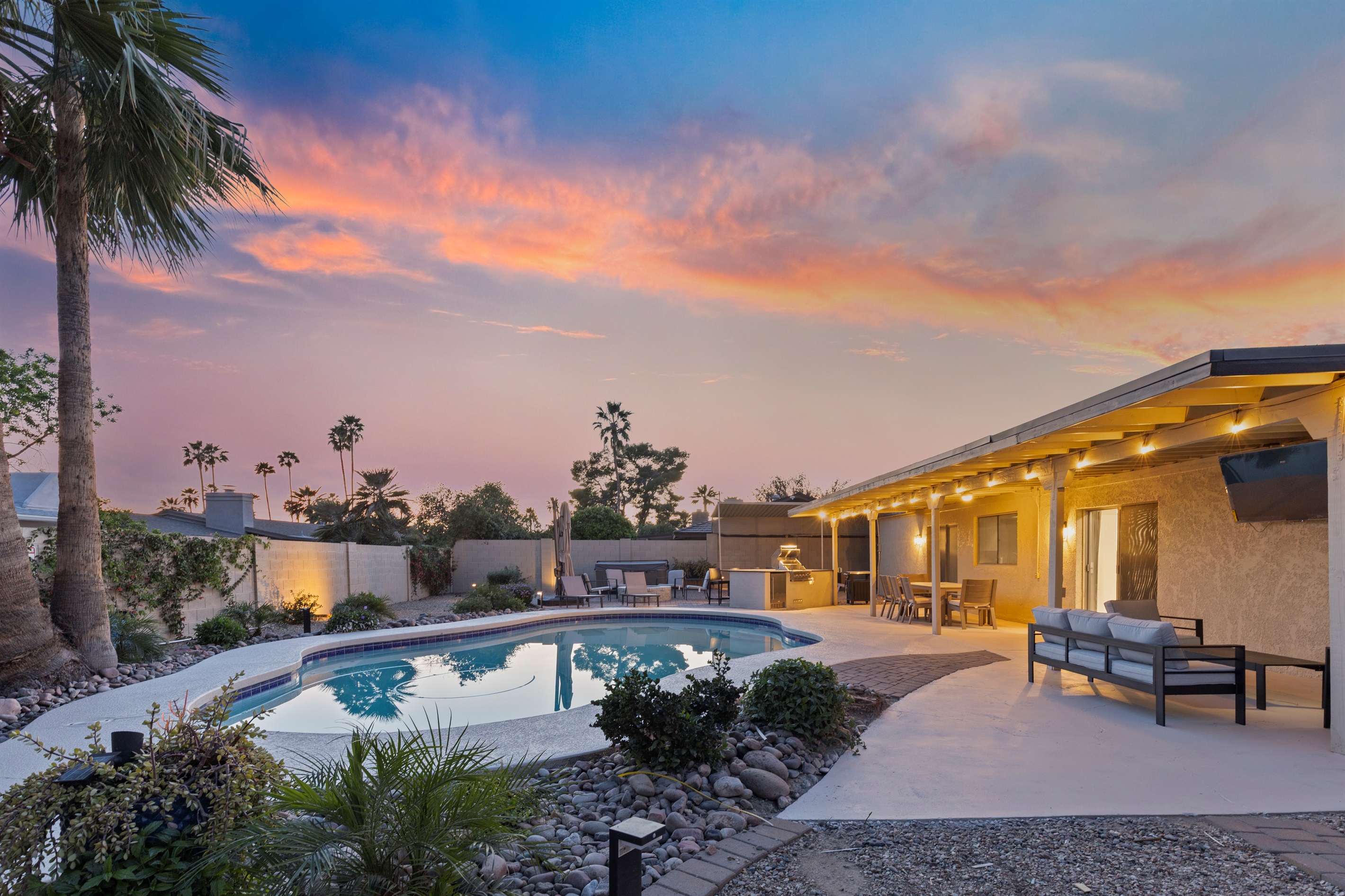 Evening lighting creates a relaxing, resort-style backyard atmosphere