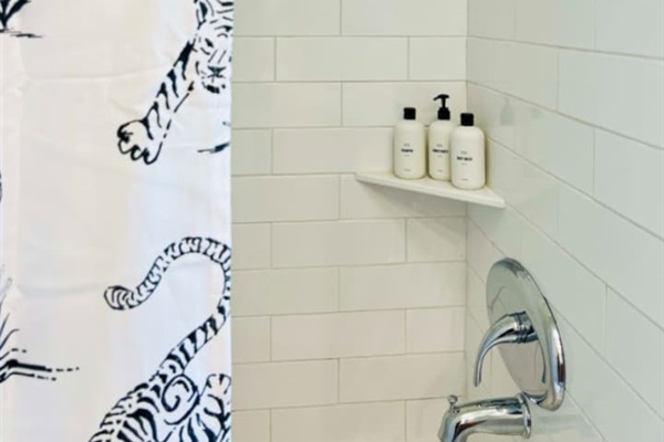 Modern full bathroom, featuring sleek fixtures and all the amenities you need for a comfortable and refreshing experience.