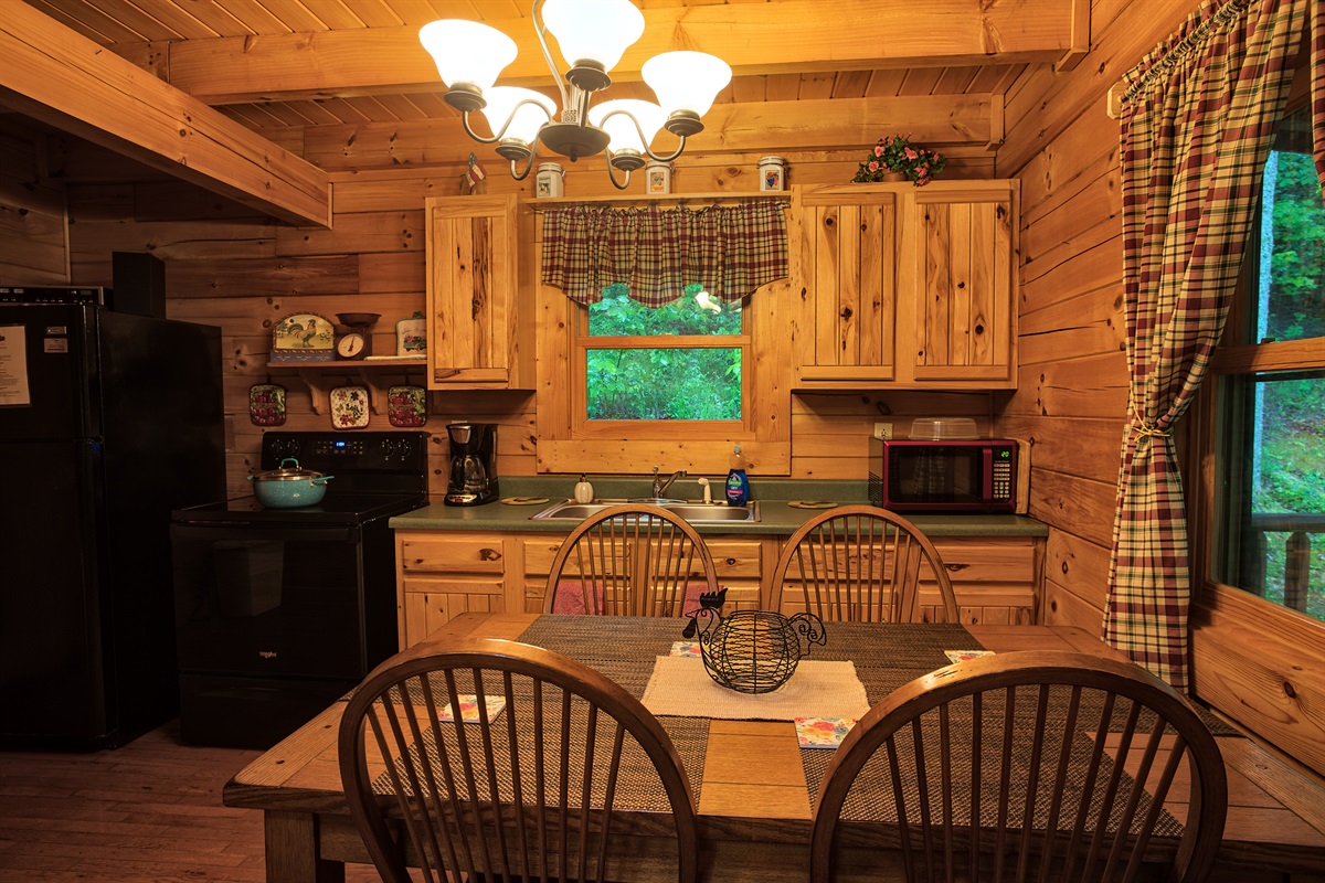 The kitchen has modern amenities, including a stove, refrigerator, toaster, coffee maker, microwave, and all the tools needed to cook romantic dinners together.