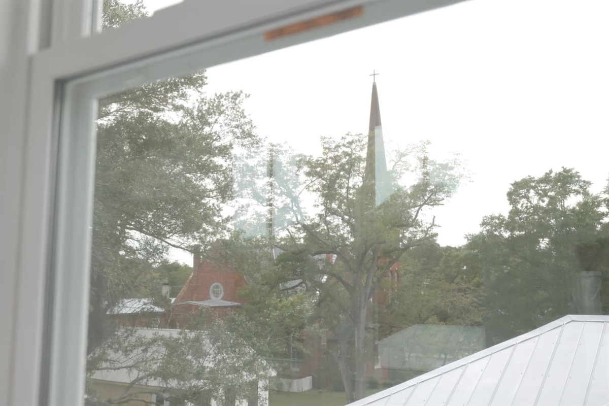 The lookout is surrounded by windows for views of the historic downtown neighborhood. Look for the church steeples.