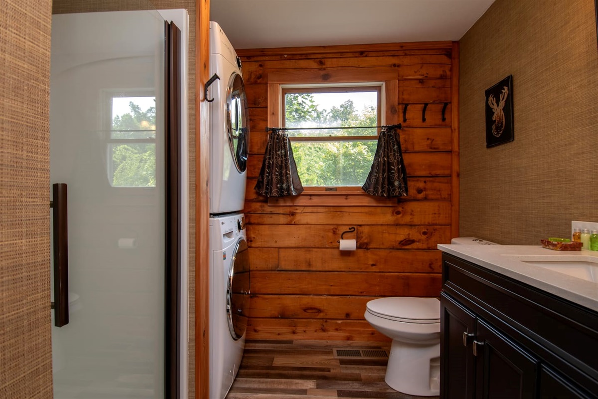 First floor bathroom with washer, dryer, iron and ironing board. Laundry detergent provided.
