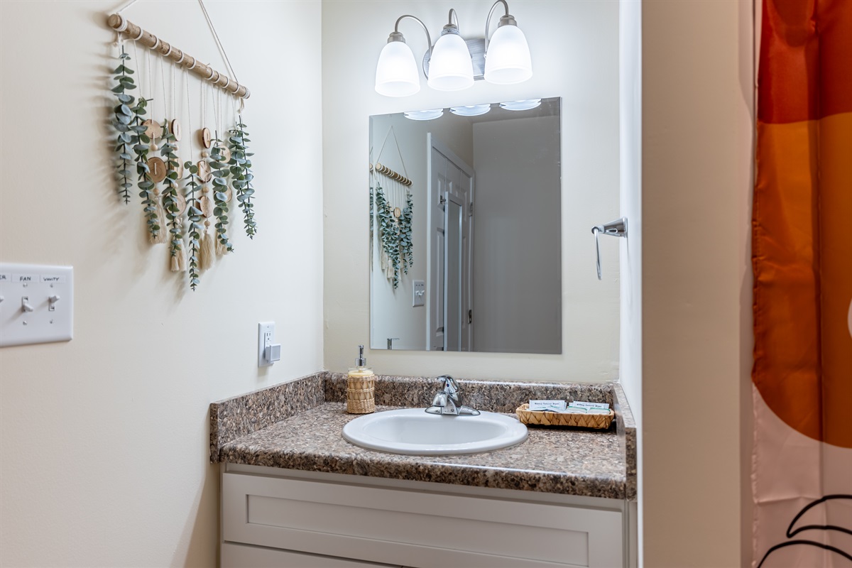 Separated vanity area with full-length mirror on door