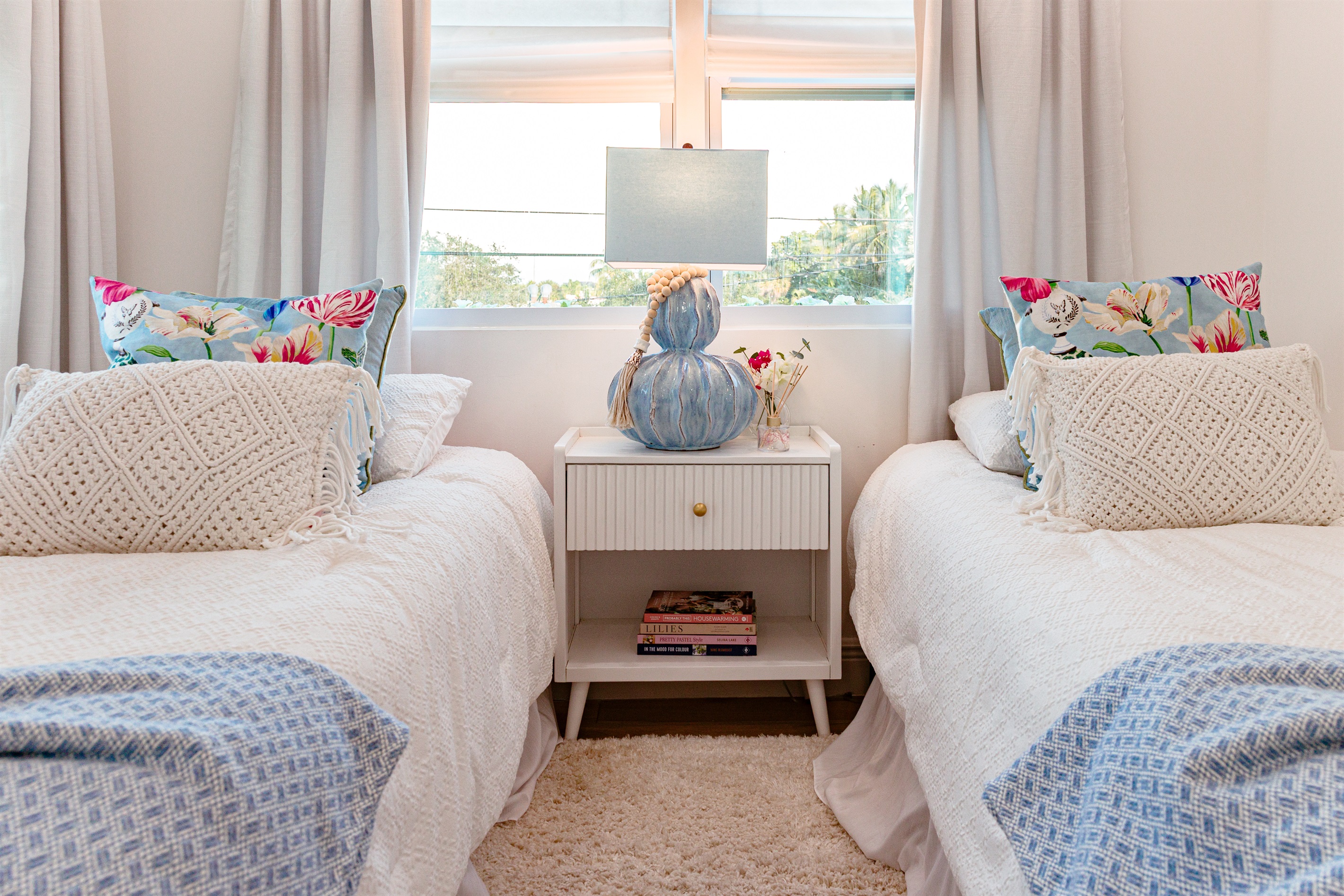 Our first cottage bedroom features two double beds, stylishly designed and very comfortable.