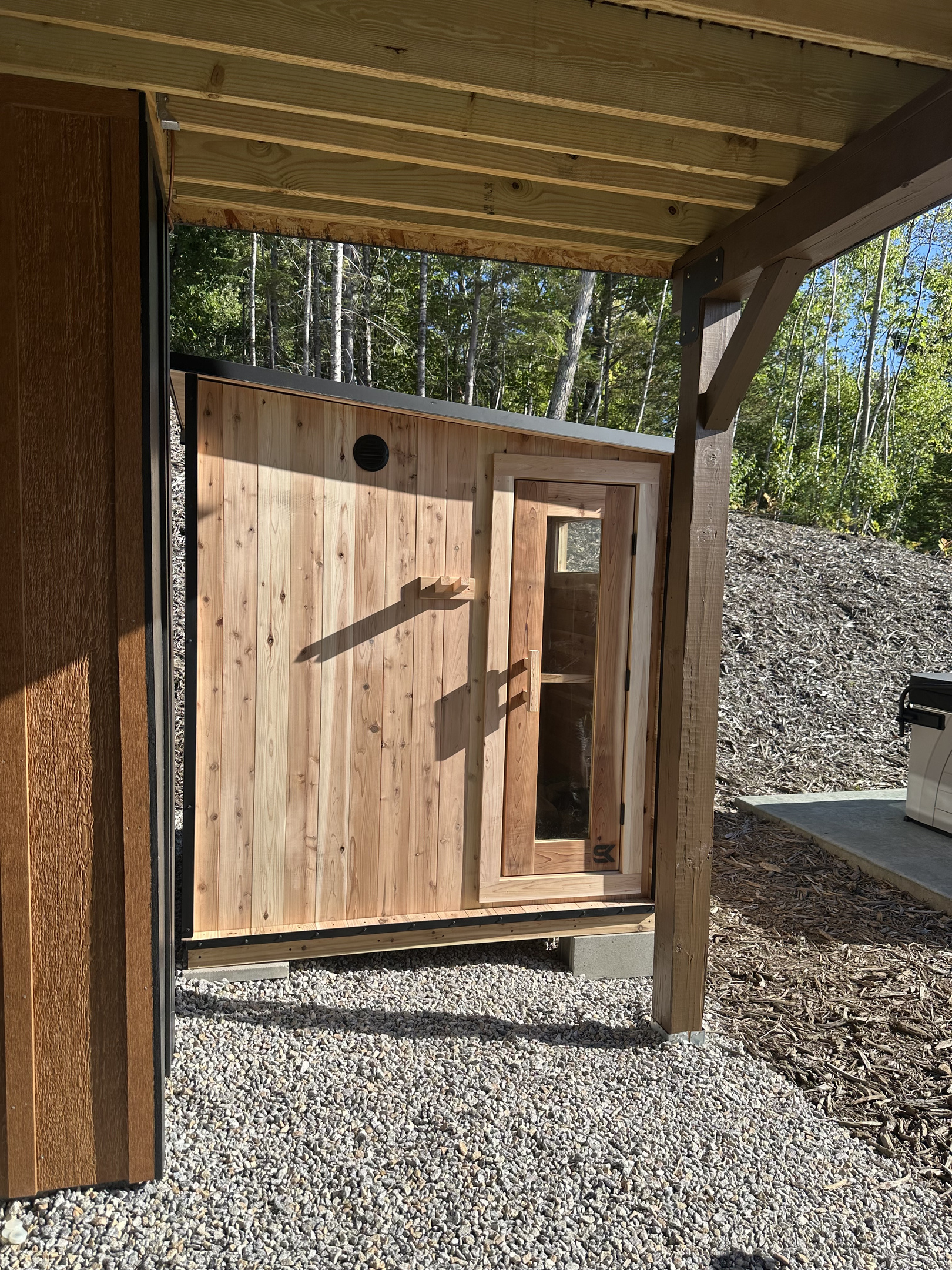 Exterior view of the private sauna, conveniently located just steps from the home.