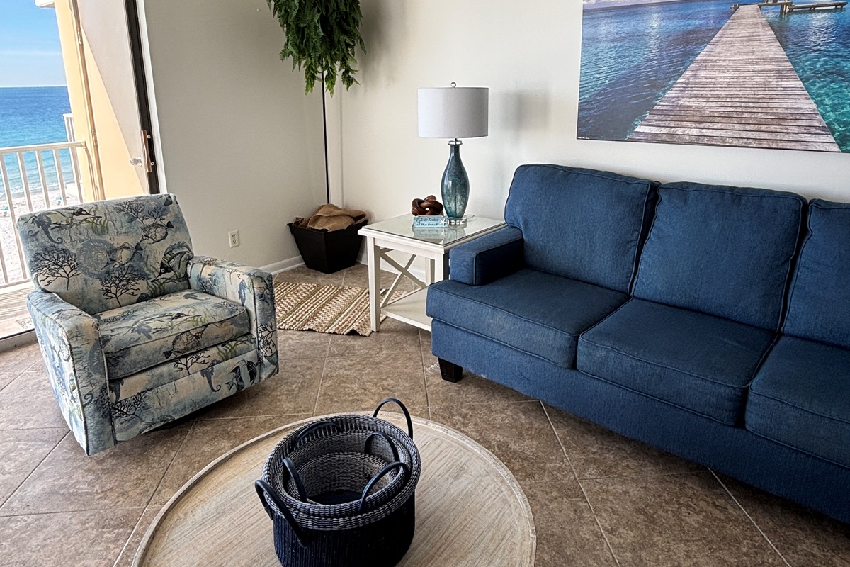 Open living space with comfortable seating and easy access to the beachfront balcony.