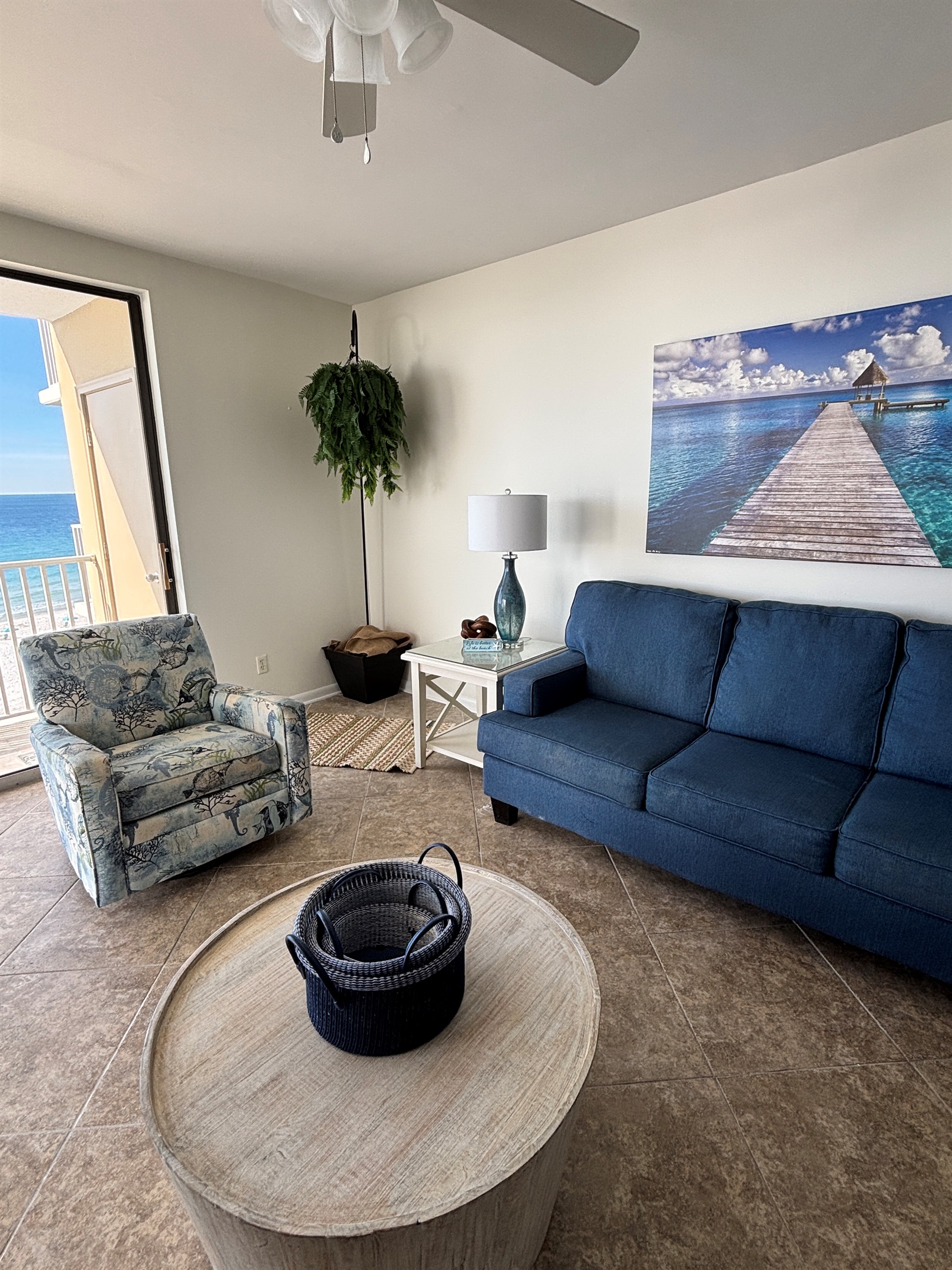 Open living space with comfortable seating and easy access to the beachfront balcony.