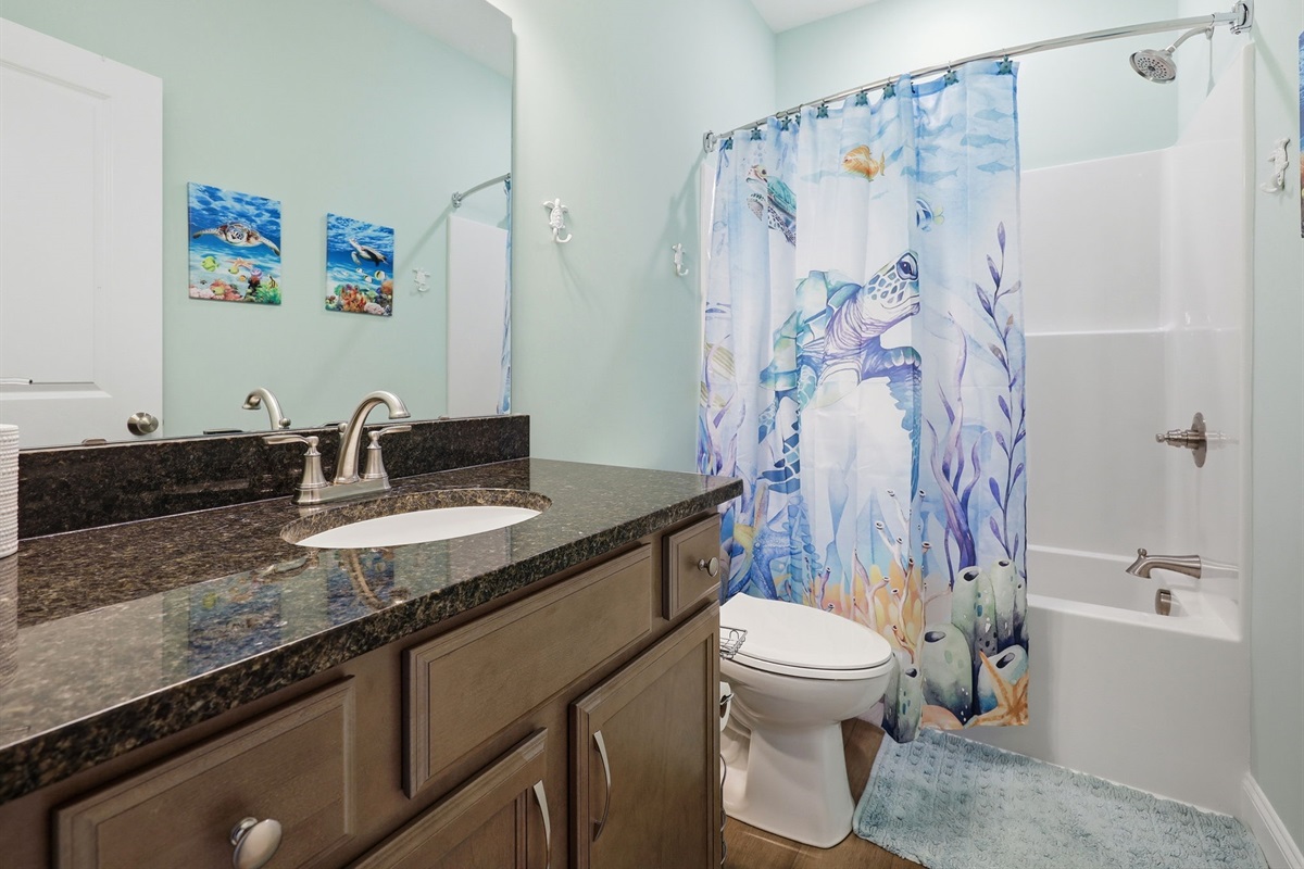 Full bathroom with tub and shower combo just steps from the bedroom