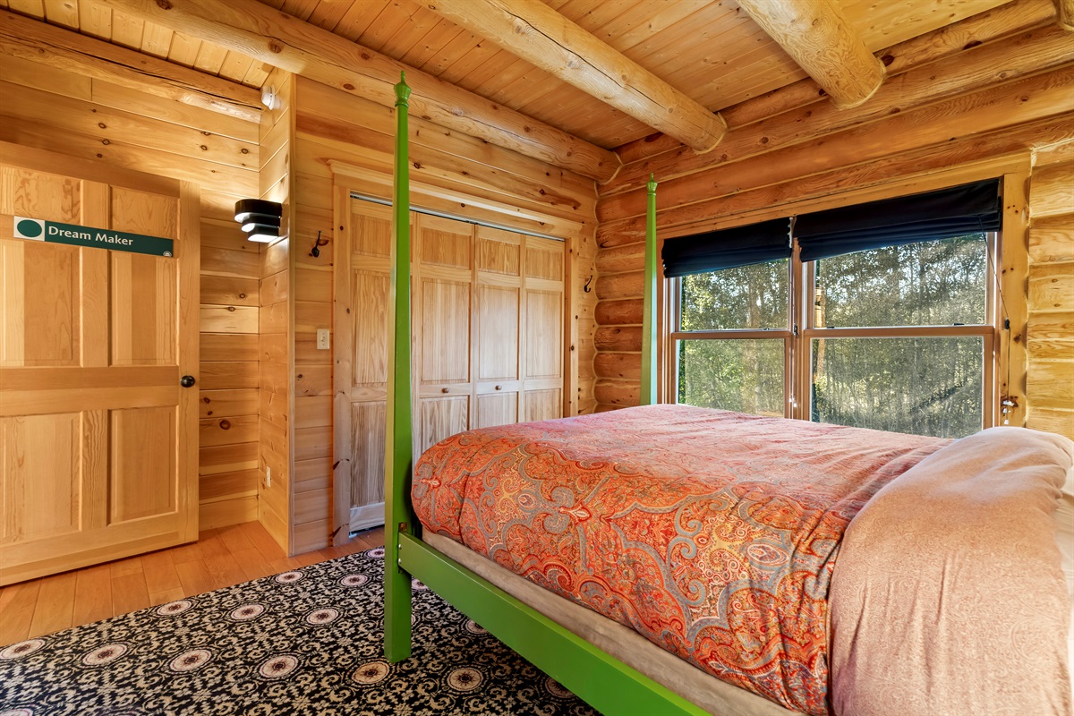 Second bedroom featuring a queen bed and plenty of storage.