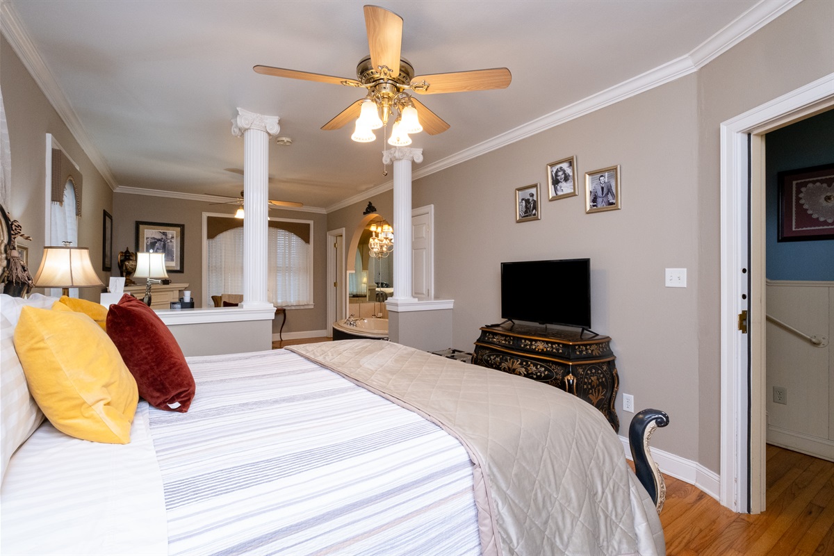 View from the sleeping area into the expansive sitting room, highlighting the suite’s open layout
