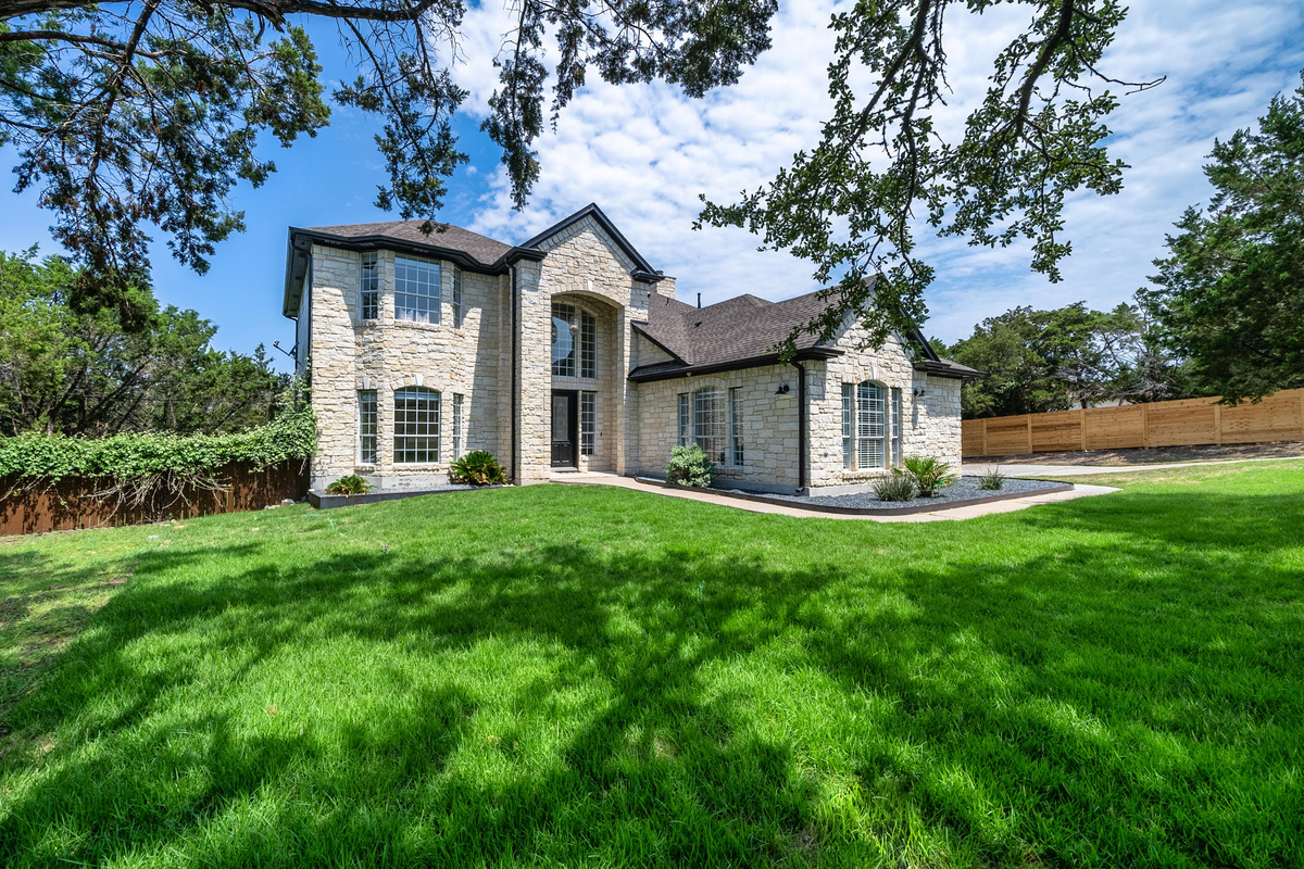 Elegant curb appeal with soaring windows and manicured landscaping.