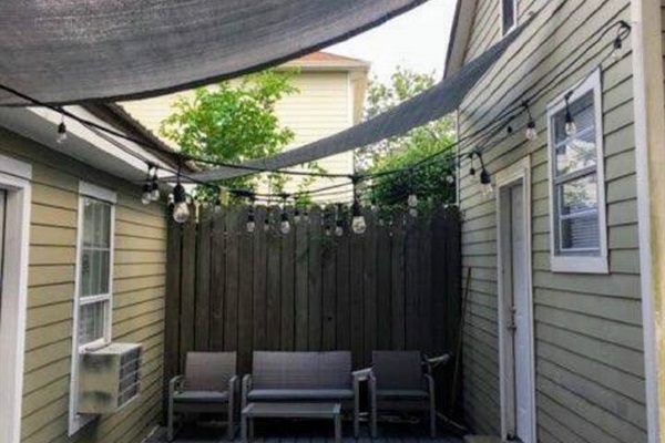 Shaded back patio, out the utility room and also accessible from the driveway.  Area is shared with another apartment.