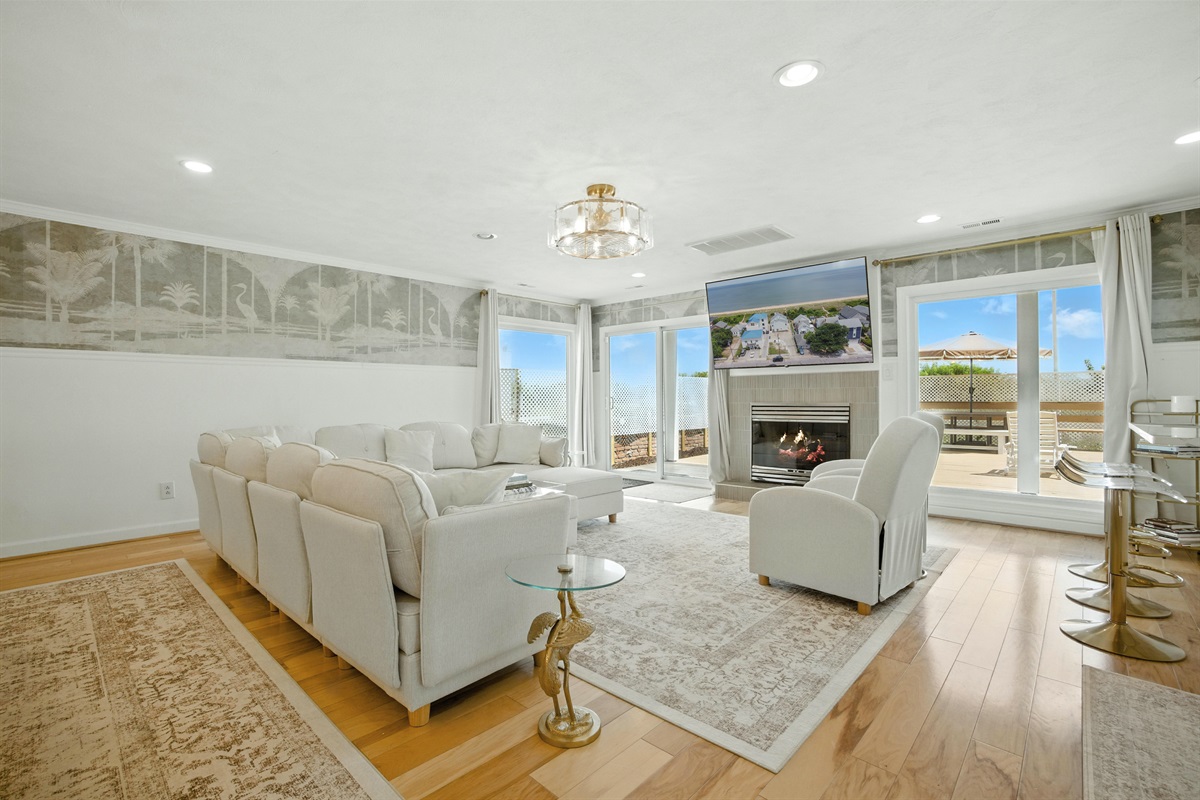 Living Room has a gas fireplace and a sliding glass door with direct access to the rear deck