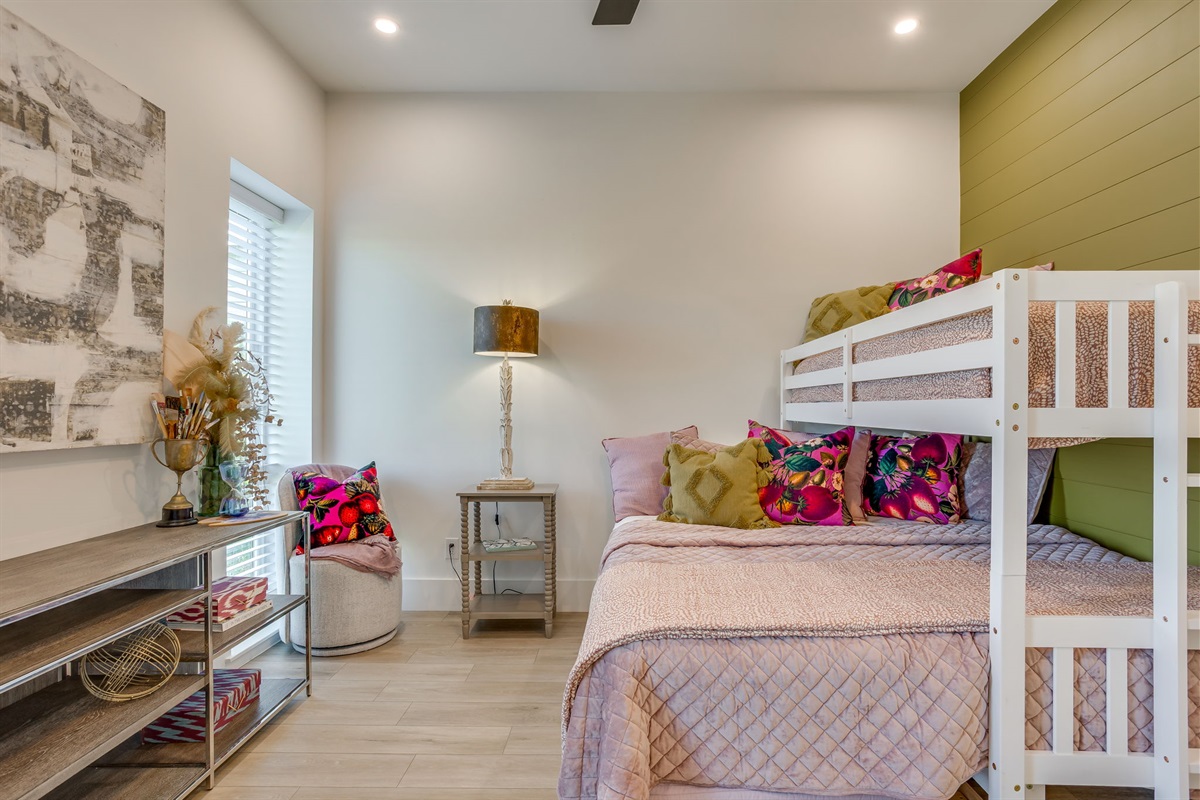 Stylish guest room at The Noir featuring a king bed with trundle and twin above, sleeping up to four guests at a luxury Lake Granbury vacation rental.