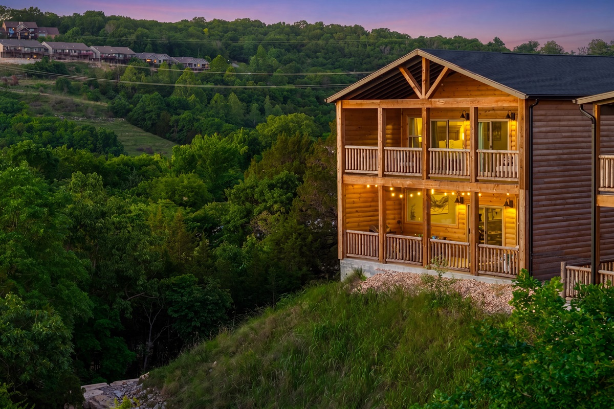 Two levels of covered porches with string lights, lake views and Ozark sunsets.