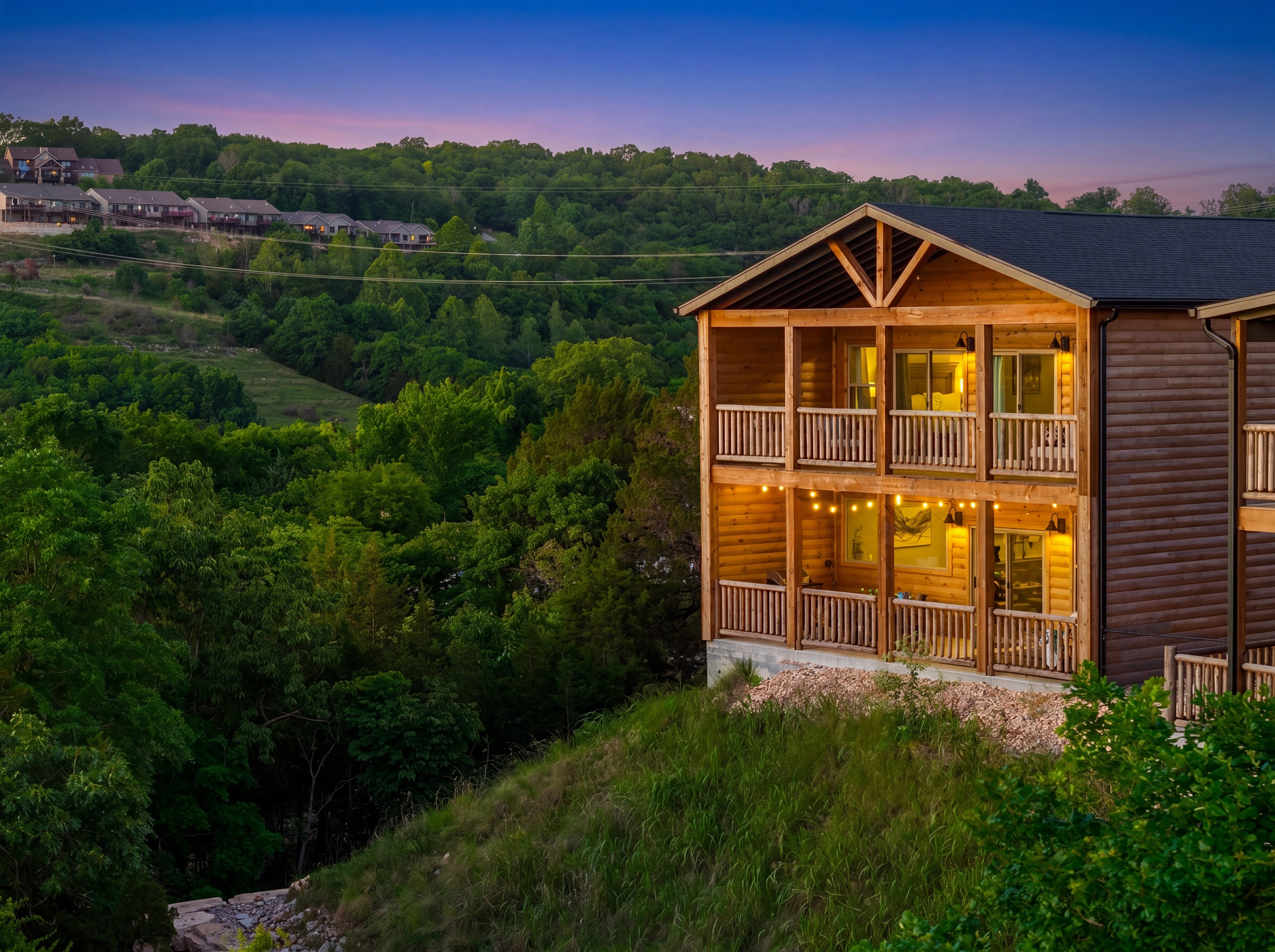 Two levels of covered porches with string lights, lake views and Ozark sunsets.