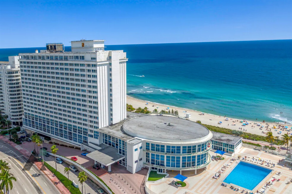 An aerial view of the building and its oceanfront pool, sitting right on the beach in Mid-Beach.