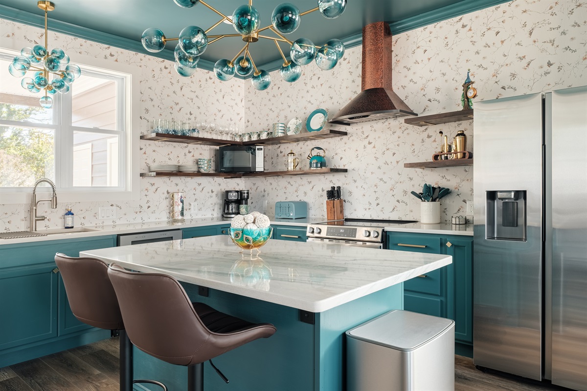 This modern, custom-designed kitchen at Bliss Escape combines luxury finishes with a welcoming, home-like atmosphere.