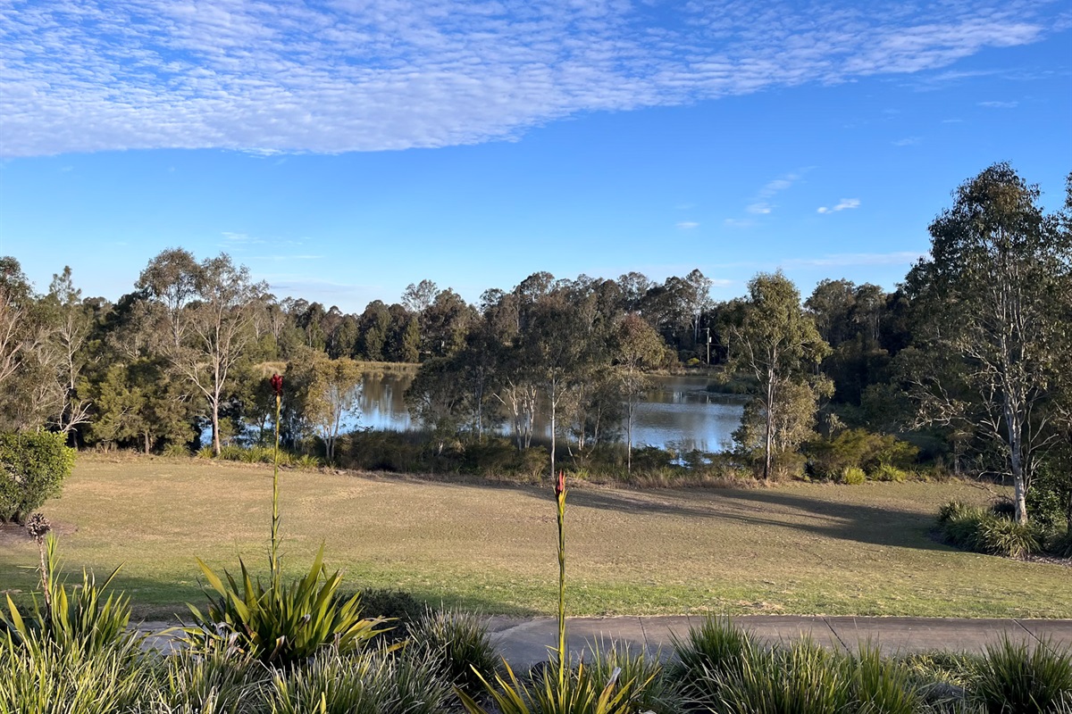 Summers Green View Retreat sits in Logan Reserve, with nearby Bayes Park lake and bushland giving the property its calm green setting.