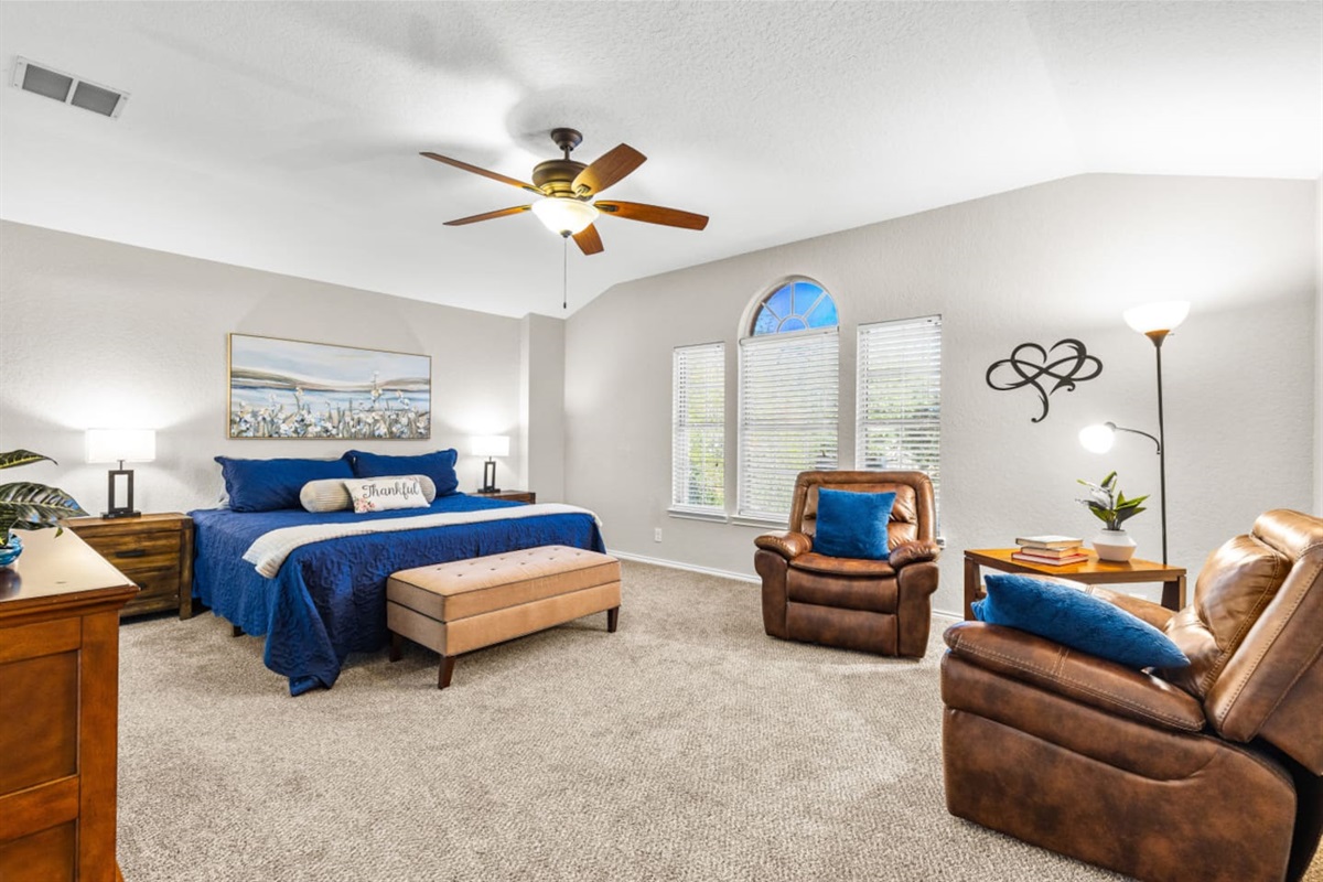 Relaxing primary retreat with a king bed, dedicated reading nook, room-darkening shades, plush linens, and a Smart TV with full streaming options.