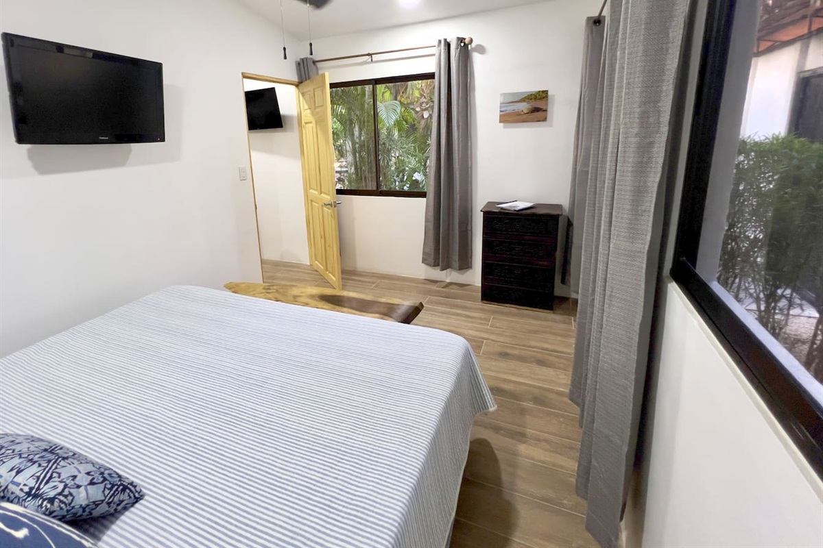 Casa Cocos king bed looking out on the garden and entrance gate.