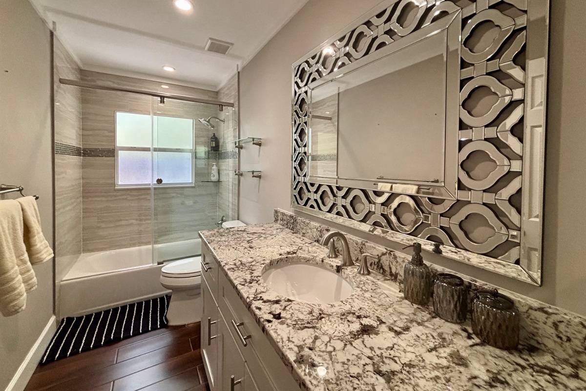 The second restroom is located between the other two bedrooms.