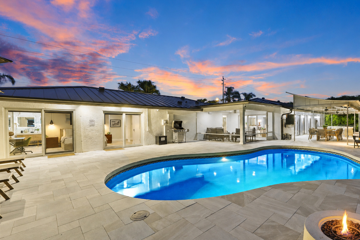 Stretch out by the private pool with shaded loungers, umbrellas, palm trees, and cornhole nearby for easy vacation afternoons.