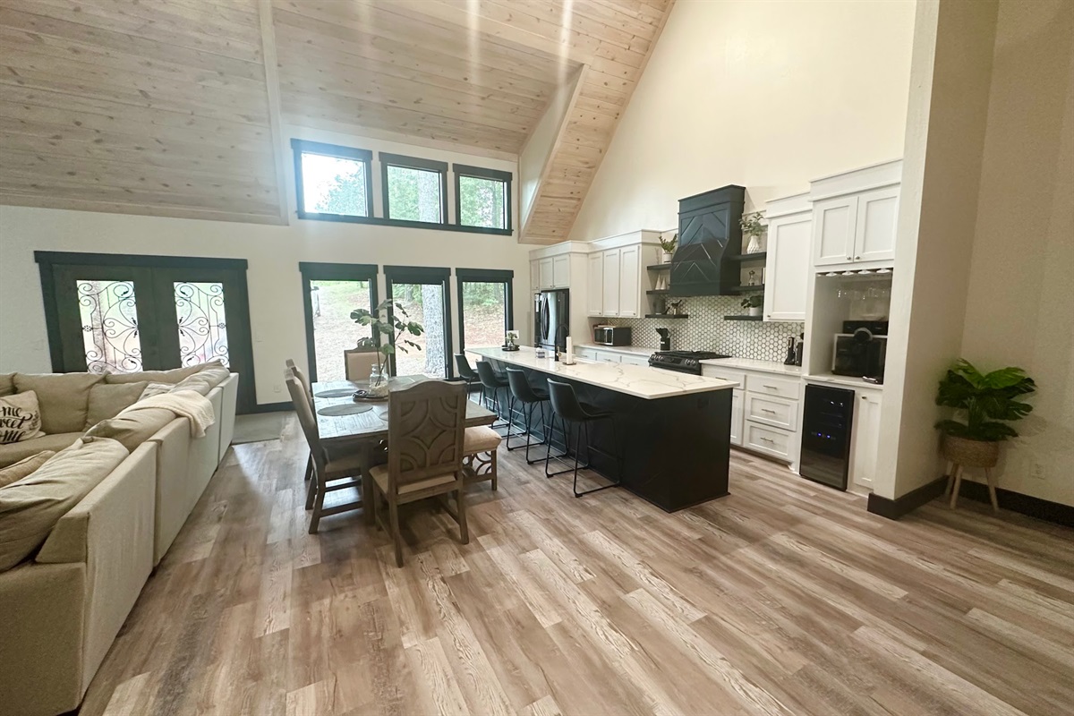 Bright open-concept living and dining area with soaring ceilings.