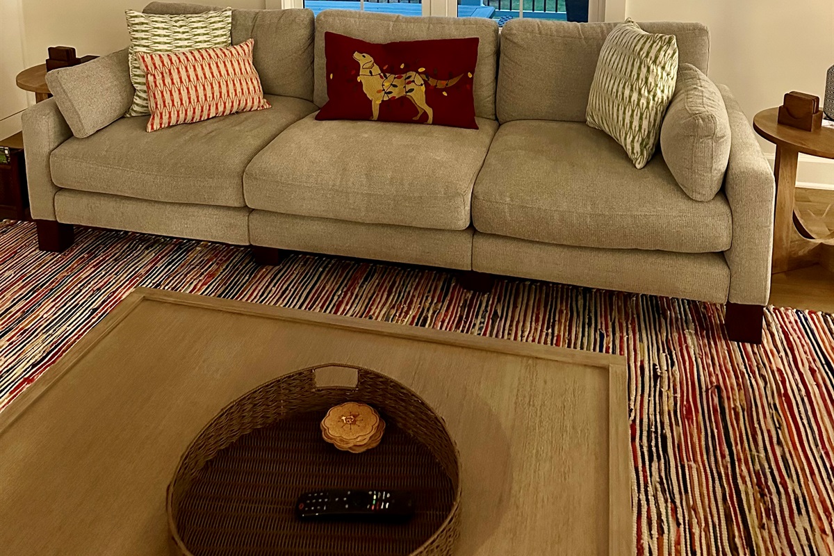 Step into holiday comfort: a decorated living room, a warm fireplace, and windows reflecting the soft glow of the Christmas tree.