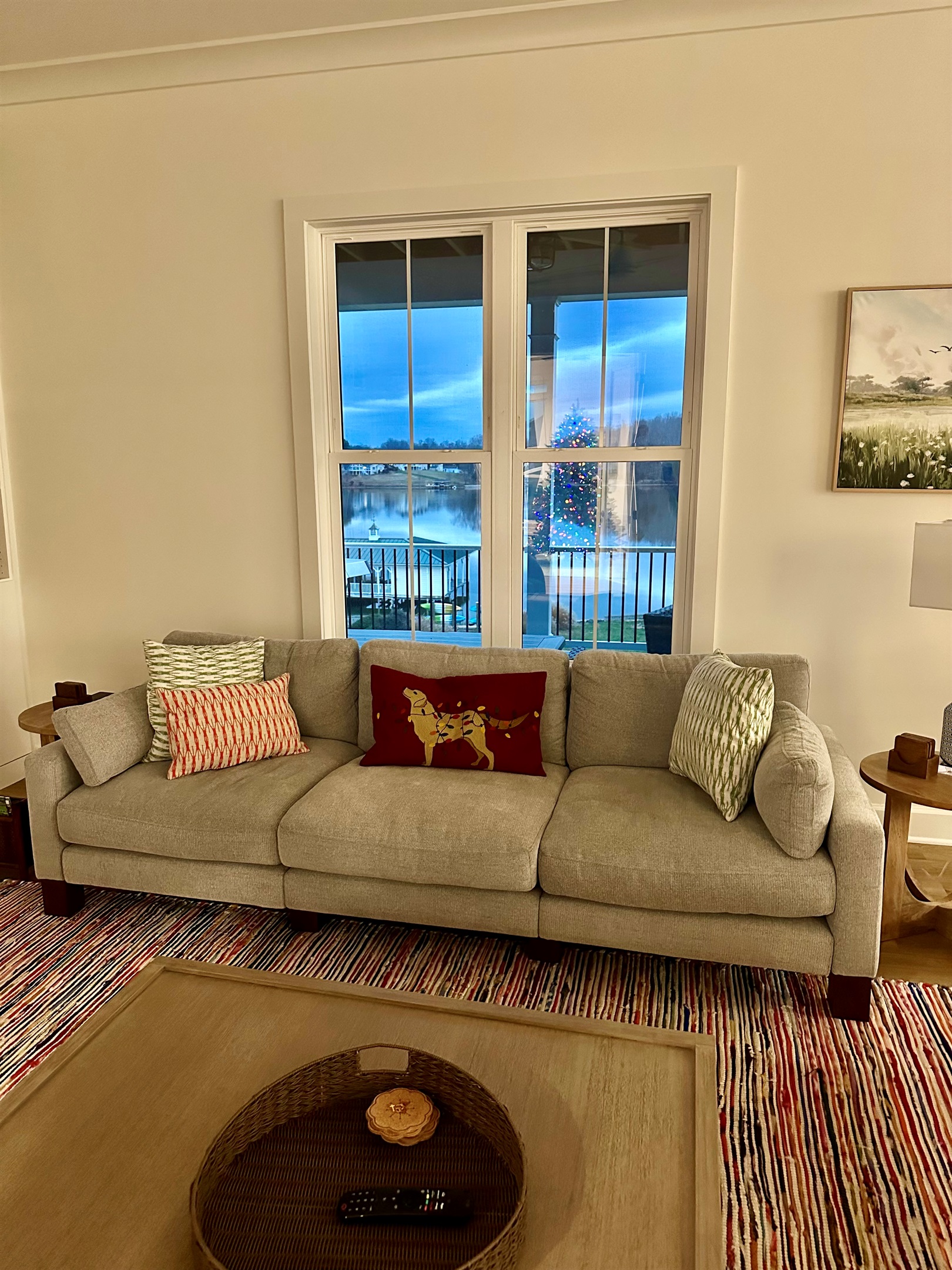 Step into holiday comfort: a decorated living room, a warm fireplace, and windows reflecting the soft glow of the Christmas tree.