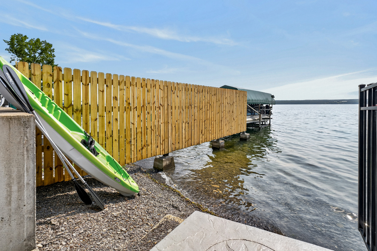 Kayaks stored beside the shoreline